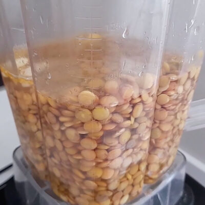 Add soaked lentils, water, Salt, Turmeric, Garlic, oil, and Lemon to the blender