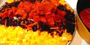 To serve Gheymeh Nesar, place a generous portion of rice on a plate and top it with the flavorful Vegan meat mixture. Garnish with the sautéed nuts, dried barberries, and sliced orange peel. 