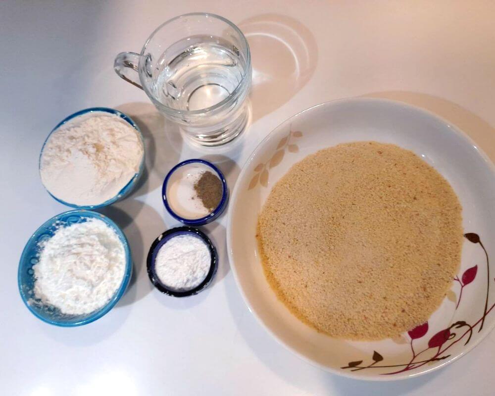 You don't need eggs. In a separate bowl, combine the following ingredients: white flour, corn flour, cornstarch, breadcrumbs, salt, black pepper, and baking powder.