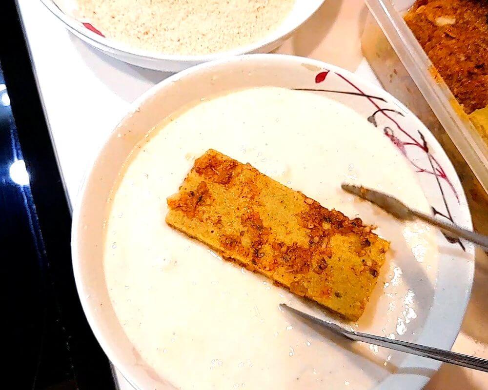 Dip the marinated tofu in the batter, then coat both sides with breadcrumbs.
