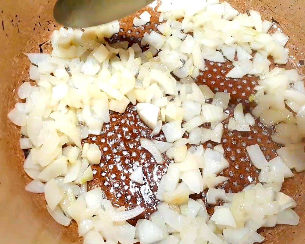 Chop an onion and fry it in a pot with some oil.